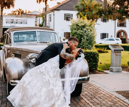Wedding couple with their classic getaway car in Northeast Florida