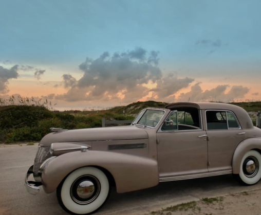 Wedding party with a classic Cadillac bridal car