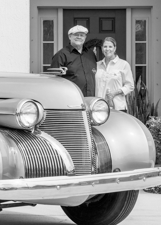 Old City Pristine Motorcars owners with their classic Cadillac in St. Augustine