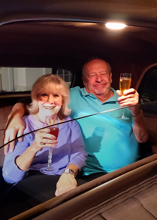 Couple enjoying a private ride inside the chauffeured classic Cadillac limo